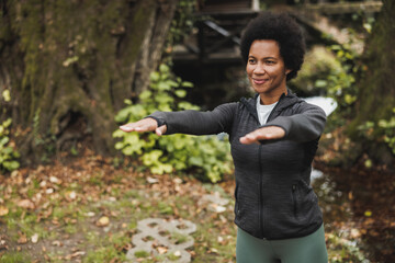 Black Woman Warming Up After Jogging In Nature