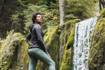 Black Woman Enjoying Near The Waterfall In Nature