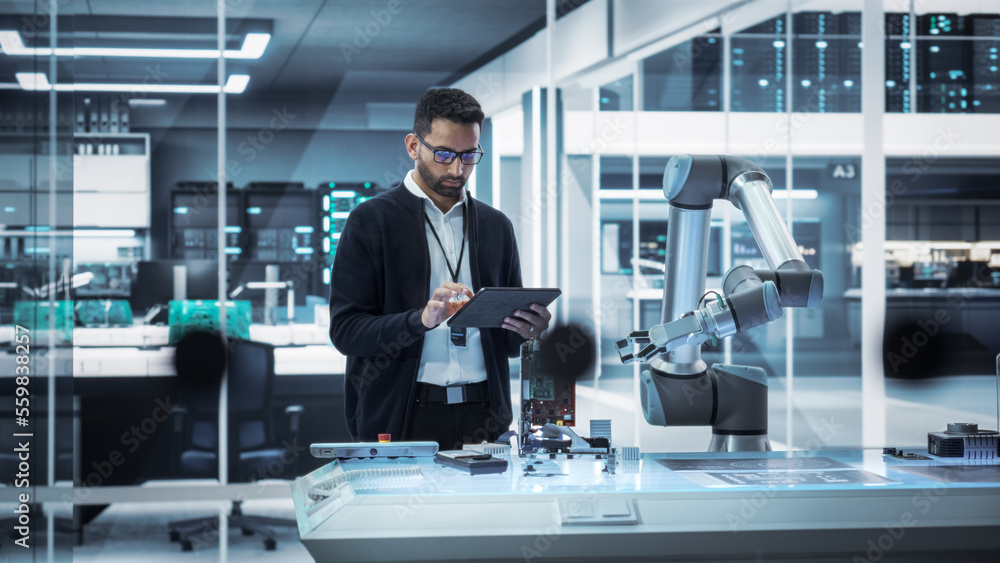 Poster Industrial Robotics Professional Interacting with Robotic Arm During a Research Phase in a High Tech Startup. Scientist Uses Tablet Computer to Manipulate and Program the Robot to Move a Microchip.