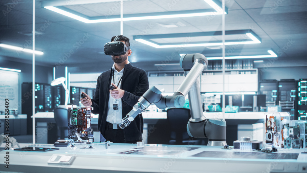 Fototapete Robotics Engineer Operating a Futuristic Robotic Arm, Using a Virtual Reality Headset and Controllers to Perform Tasks. Work in Research and Development High Tech Facility Startup.