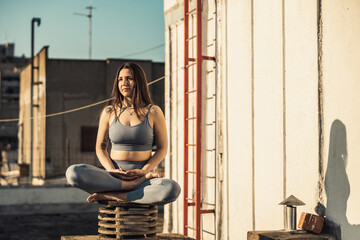 Woman Meditating Outdoors On A Rooftop Terrace