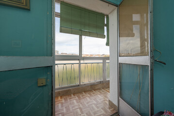 Old glazed terrace of an old house with sintasol floors and roller blinds with ropes