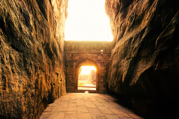 Beautiful sunlight coming out of Badami fort ,gateway to lower Shivalaya temple during sunset.