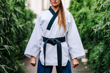 Anonymous professional TKD master standing on street