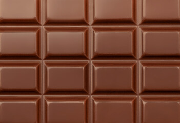 Dark Milk chocolate bar as a background. Flat lay, top view. Sweet chocolate food Pattern.