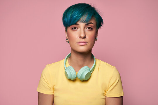 Young Woman With Headphones Around Neck Standing In Studio