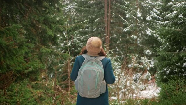 woman in forest enjoys nature, slow motion, tranquility and self-knowledge, winter and white snow. alone with yourself.