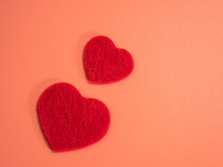Red color heart on a pink background.