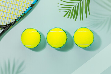 Tennis competition card. Sport composition with yellow tennis balls and tennis racket on a blue...
