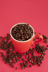 coffee beans in a cup on red background