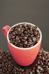 coffee beans in a cup on black background