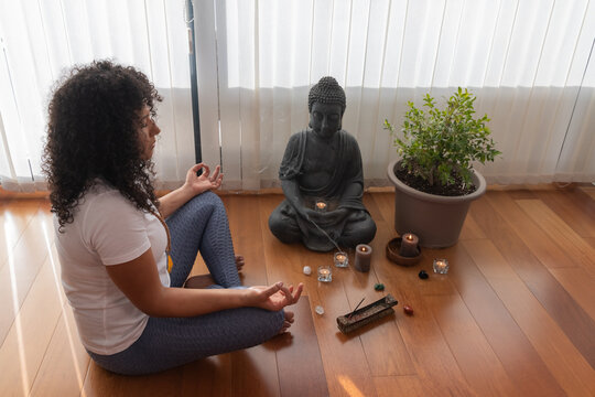 Calm woman meditating in Padmasana pose with namaste gesture