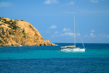 Fototapeta na wymiar A yacht moored by the beach in Sardinia on a sunny day