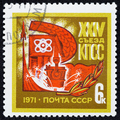 USSR - CIRCA 1971: Postage stamp 6 kopeck printed in the Soviet Union shows Atom, taking off a rocket with stars and a book with a spikelet. Post stamp series devoted to XXIV Congress of the CPSU.
