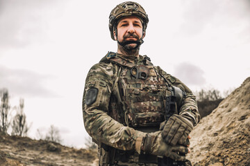 Mature man in military uniform and protective hemlet