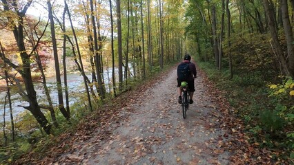 Obraz premium biking solo adventure through the woods by a river