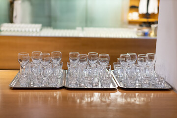 many drinking glasses on trays