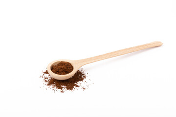 Freshly ground coffee in a wooden spoon isolated on white background.