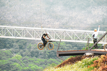 Dashbashi, Georgia- 19th JUne, 2022: man pedal zip bike over valley in beautiful caucasus mountains