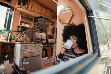 Woman relaxing in her camper van