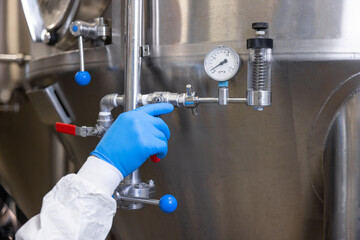 Engineer releasing the pressure in the fermentation tank