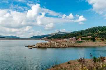 The artificial dam of Aposelemi and the abandoned sunken village of Sfendili which is sinking in an...