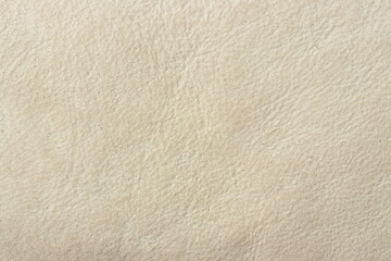 Genuine leather (sheepskin) with beige surface, texture animal skin. Background with copy space for text or product due to nice yellow pattern.