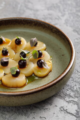 Scalops in sauce served with fresh berries on top. Food in restaurant.