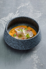 Cream soup served with vegetables in restaurant