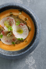 Cream soup served with vegetables in restaurant