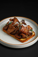 Toast with grilled beef served with herbs on top