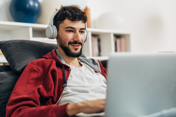 Gamer plays the game on his laptop and smiles