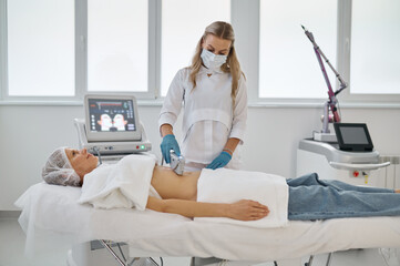 Obraz premium Laser epilation and cosmetology in beauty salon