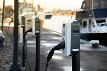 Electric car charging station next to the port. Car charging next to the water.