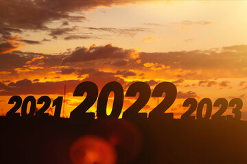 Year change. The beginning of a new year. New year concept. Symbol of start and greetings happy new year 2022. People enter 2022.