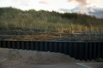 Wicker fence with metal fence. Path protection.