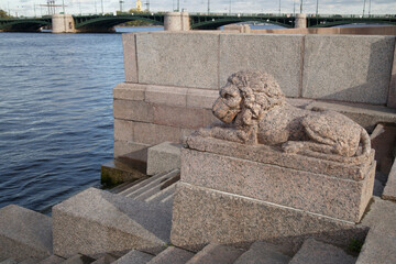 Granite sculpture of a reclining lion outside.