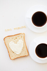 sandwich for breakfast in form of heart with cheese - good morning sign and two coffee cups