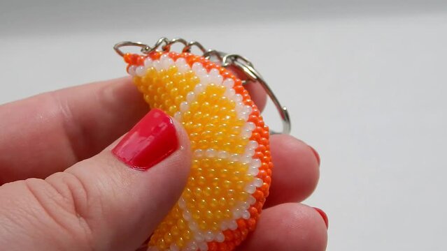 Colorful keychain lies on a woman's palm