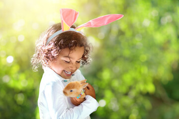 Little curly boy with Easter bunny.