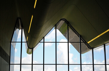 Interior View of Modern Public Space with Glass Wall and Undulating Roof 
