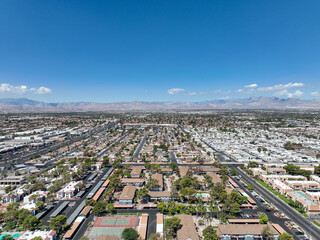 Aerial view across urban suburban communities in Las Vegas Nevada with streets, rooftops, and homes 