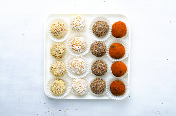 Assorted vegan sweets, Delicious Candy Balls with seeds, dried fruit and cocoa powder, Healthy Candies