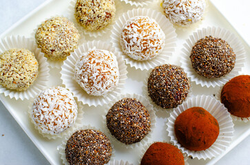Assorted vegan sweets, Delicious Candy Balls with seeds, dried fruit and cocoa powder, Healthy Candies