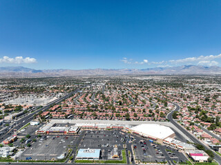 Aerial view across urban suburban communities in Las Vegas Nevada with streets, rooftops, and homes 