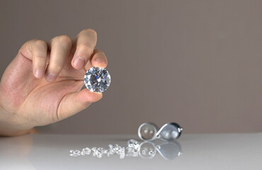 Gem stones diamonds of different cuts and sizes on the desktop of diamond dealer evaluating quality...