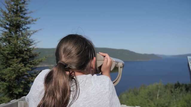 Young girl looking through binoculars
