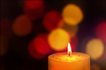 Beautiful candle with bright flame on dark background