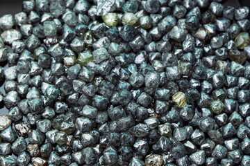 Rough technical industrial quality diamonds on black background. High quality photo