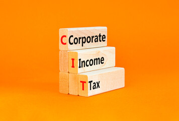 CIT corporate income tax symbol. Concept words CIT corporate income tax on wooden blocks on a beautiful orange table orange background. Business and CIT corporate income tax concept. Copy space.